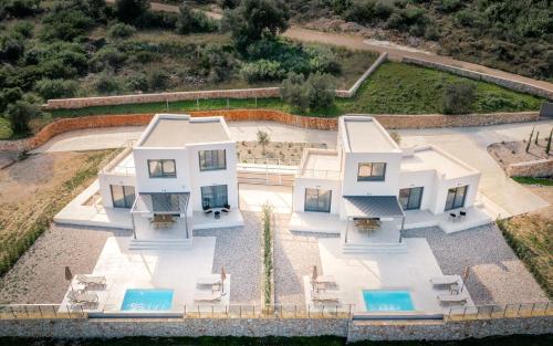 an aerial view of a white house at Ventalia Villas, 3BR Sea View and Infinity Pool by Villa Mana Gers in Agios Nikolaos