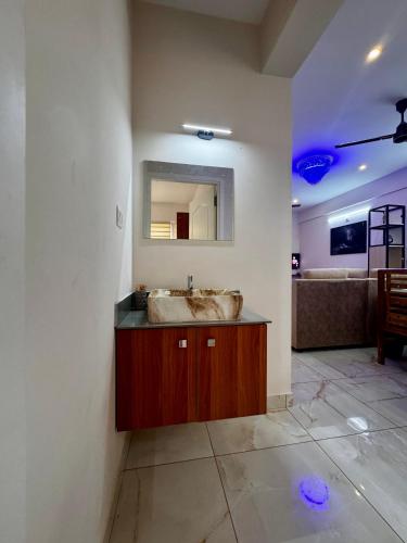 a bathroom with a sink and a mirror at Zenith apartement in Trivandrum