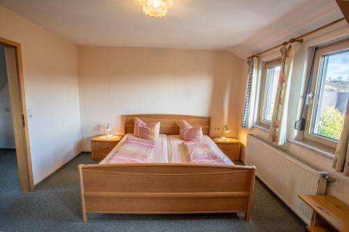 a bedroom with two beds and two windows at Gutshof Colmberg in Colmberg