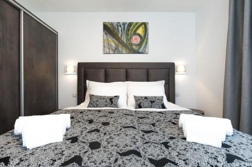 a bedroom with a large bed with two pillows at Villa Aurora in Baška
