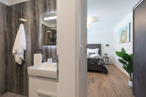 a bathroom with a sink and a bed in a room at Villa Aurora in Baška