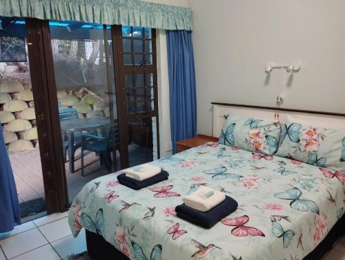a bedroom with a bed with towels on it at Boathouse Bed and Biscuit - Cabin in Margate
