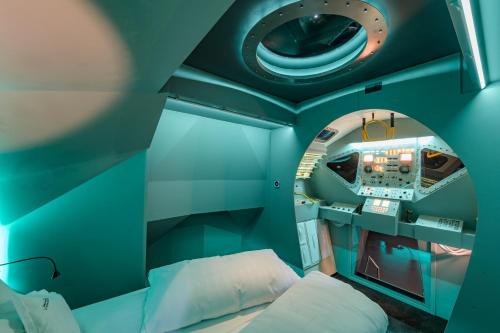 a small room with a bed and a round window at Apollo11 in Collepietra