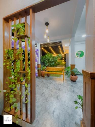 a living room with a bench and some plants at Lakshani Villa in Polonnaruwa