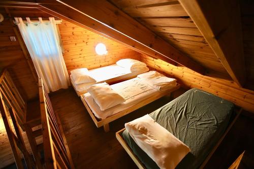 an overhead view of two beds in a wooden cabin at נופים בלבן - בקתה עם בריכה פרטית ואמבט ספא in Moshav Ramot