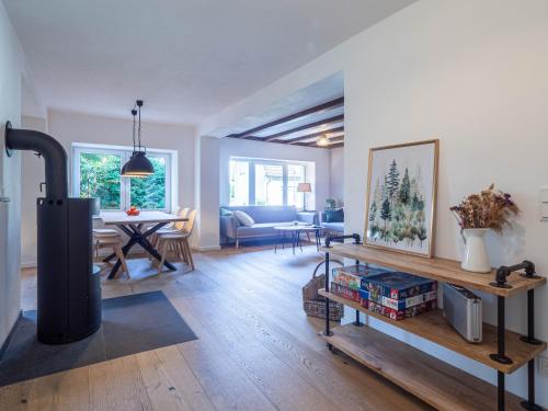 a living room with a fireplace and a dining room at Fuchsbau nähe Sorpesee, ebenerdig mit Kamin und Garten in Sundern