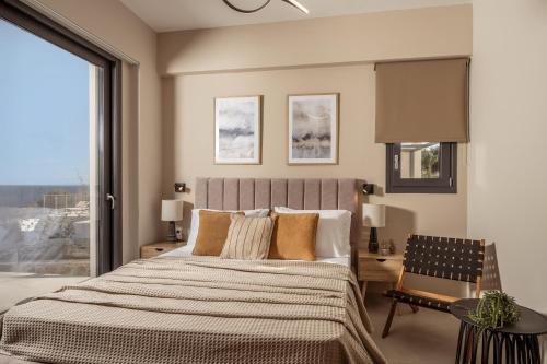 a bedroom with a large bed and a window at Ventalia Villas, 3BR Sea View and Infinity Pool by Villa Mana Gers in Agios Nikolaos