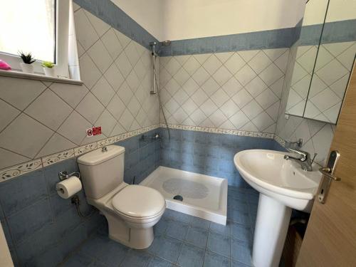 a bathroom with a toilet and a sink at Villa Christina Nidri in Nydri