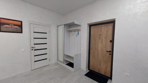 an empty room with a door and a closet at Уютная квартира в Одессе in Odesa