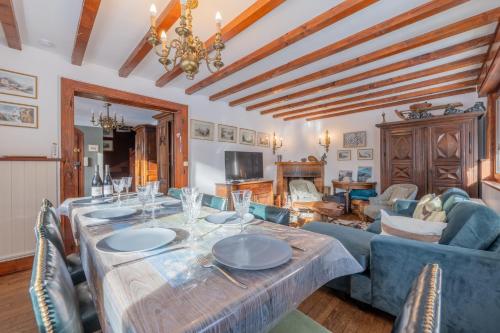 a living room with a table and a couch at Chalet Ecureuil Family retreat w/ Garden & Fireplace - Happy Rentals in Chamonix