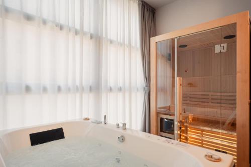 a bath tub in a bathroom with a window at Boutique Casa Giulietta Luxury in Como