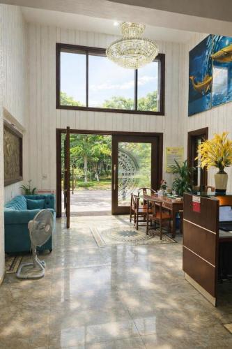 a living room with a blue couch and a table at Phương Anh Villa 1 in Bắc Ninh