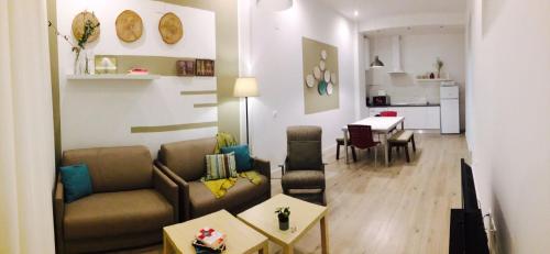 a living room with a couch and a table at Apartamentos La Estación M&S in Albacete