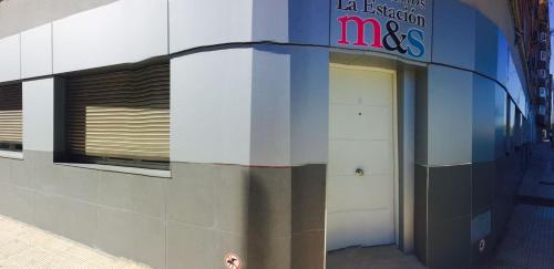 a building with a mcas sign on the side of it at Apartamentos La Estación M&S in Albacete