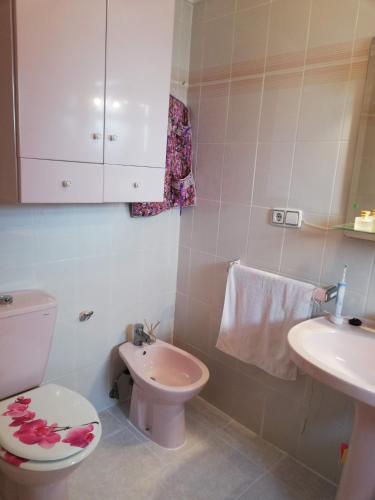 a bathroom with a toilet and a sink at Les Motes Solo Familias Serviplaya!!! in Playa de Xeraco