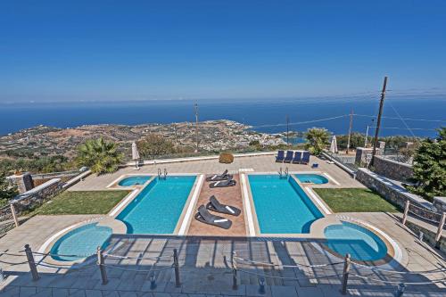 a swimming pool with a view of the ocean at Sea Views at villa Anemomylos with Heated Pool, Ping Pong and Tennis in Agia Pelagia
