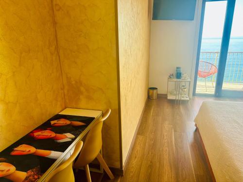 a bedroom with a bed and a table and chairs at BluMare ArtHouse in Salerno