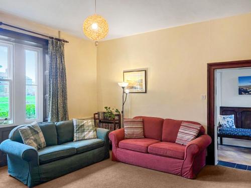 a living room with two chairs and a couch at High Rylands in Arncliffe