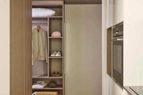 a walk in closet with a coat and shoes at Base Geneva in Geneva