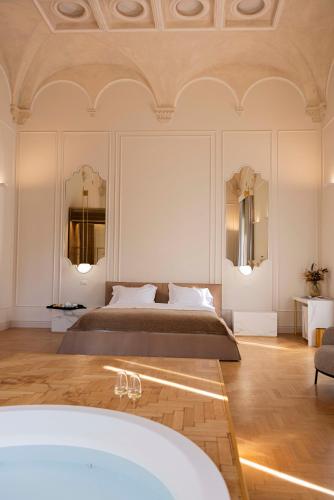 a bedroom with a bed and a bath tub at Palazzo Zimara - The D'Angelo Family Collection in Lecce