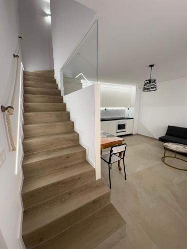 a staircase in a living room with a couch at Casa Brillantes Completa in Ayerbe