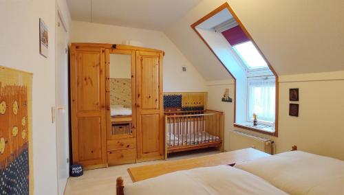 a bedroom with a large wooden cabinet and a window at Apartment Pawelzig in Kirchdorf
