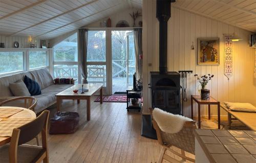 a living room with a couch and a fireplace at Tziki in Fanø