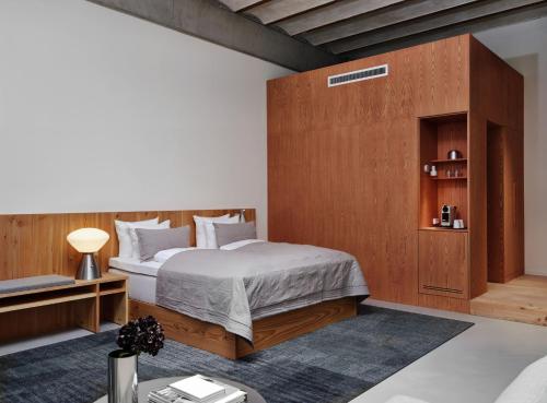a bedroom with a bed with a wooden headboard at Ottilia Heritage in Copenhagen