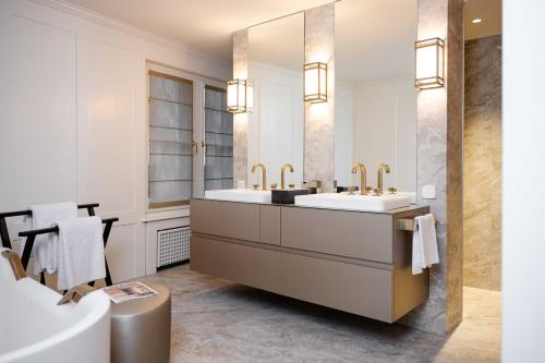 a bathroom with two sinks and a large mirror at MEWS House Zürich in Zurich
