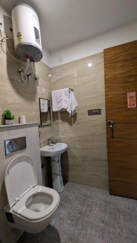 a bathroom with a toilet and a sink at Chill pad in Dehradun