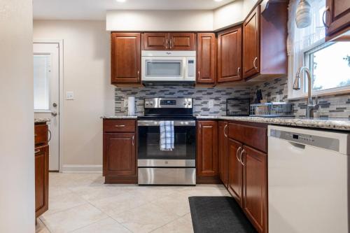 a kitchen with wooden cabinets and a stove top oven at 5 Woods Dr in Mechanicsburg