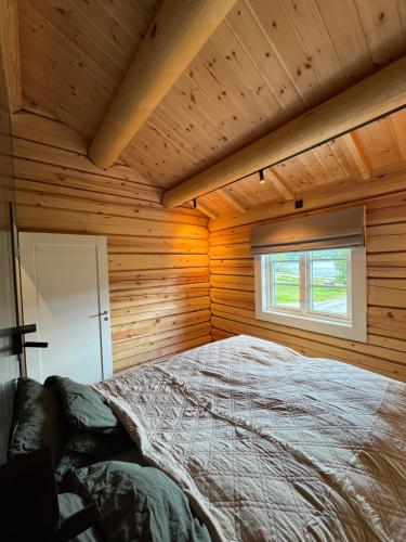 a bedroom with a bed in a wooden cabin at Gunhild-stugu in Skogbygd
