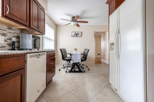 a kitchen with a refrigerator and a table with chairs at 5 Woods Dr in Mechanicsburg