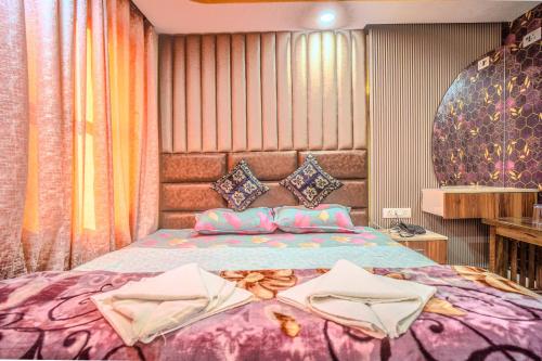 a bedroom with a bed with two towels on it at Hotel Sahil - City Center, LalChowk in Srinagar