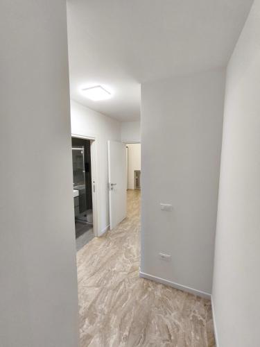 an empty room with white walls and a hallway at Grace House in Padova