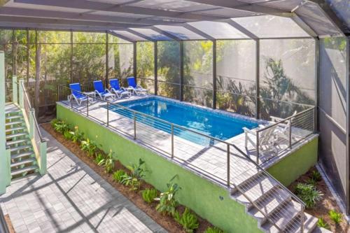 a house with a swimming pool in a greenhouse at Dancing Dolphin in Captiva