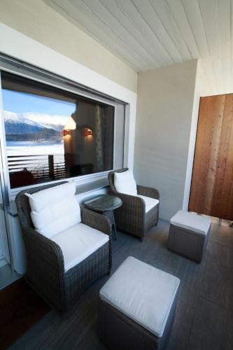a room with two chairs and a window with a view at Chesa Cuntainta B 4pax - St Moritz in St. Moritz