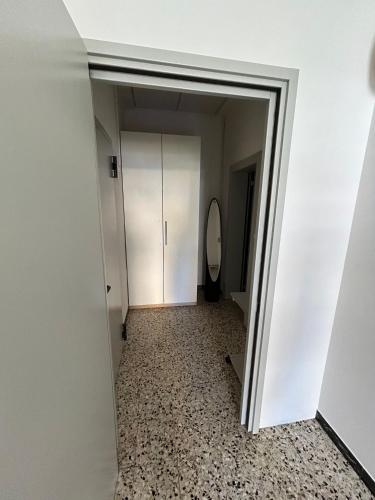 a hallway with a door leading to a bathroom at Hotel Bianca Vela in Rimini