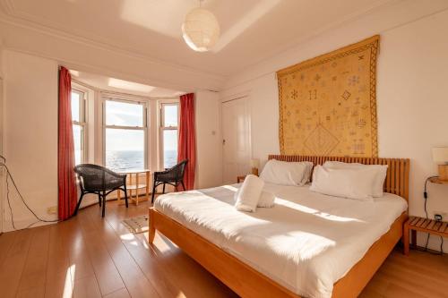 a bedroom with a large bed and a large window at Appleton House - Lower Largo in Lower Largo