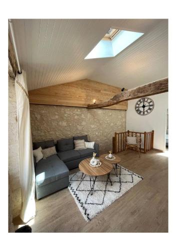 a living room with a couch and a table at La Pierre Pourpre in Eymet