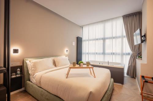 a bedroom with a bed with a table on it at Boutique Casa Giulietta Luxury in Como
