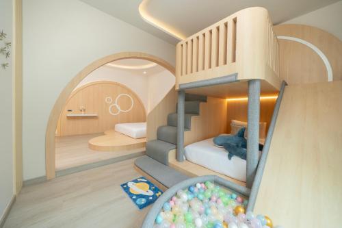 a doll house with a bunk bed and a slide at De Lunar Kohlarn in Ko Larn