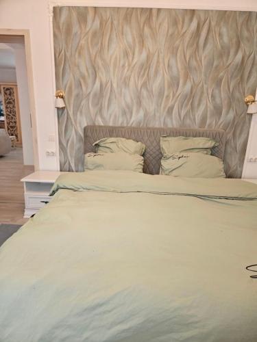 a bedroom with a large bed with a wooden headboard at Rowlands Way 3 in Ţegheş