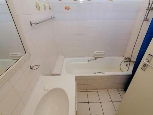 a white bathroom with a tub and a toilet at Rosscarbery 6 in Margate