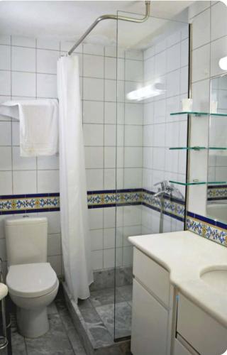 a bathroom with a toilet and a shower and a sink at Loft House Syros in Ermoupoli