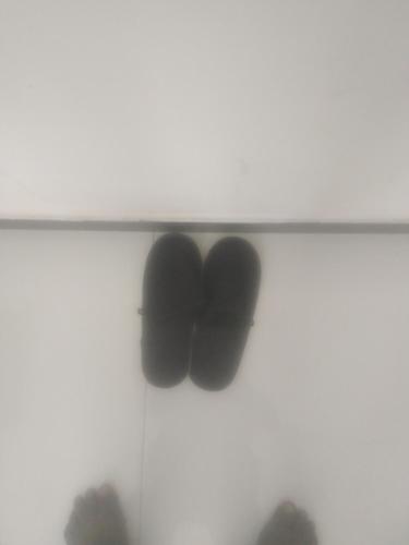a shelf with three black shoes on it at Solace Transit Villa in Katunayaka