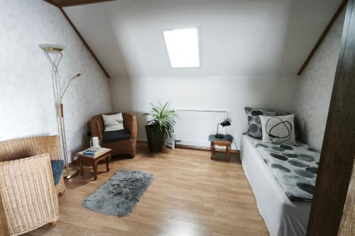 a living room with a couch and a chair at Gästewohnung Urfttalsperre in Schleiden