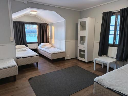 a room with two beds and a mirror at Visulahti Cottages in Mikkeli