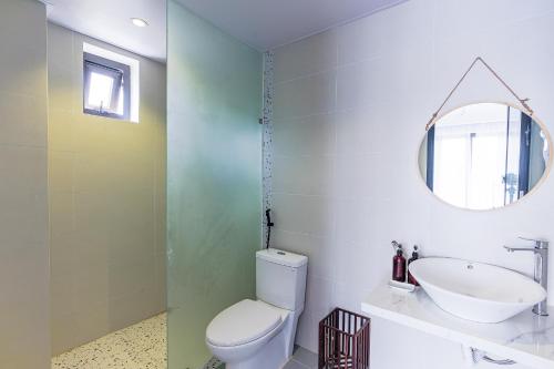 a bathroom with a toilet and a sink and a mirror at Cocohamlet Villa in Thanh Ðông (1)