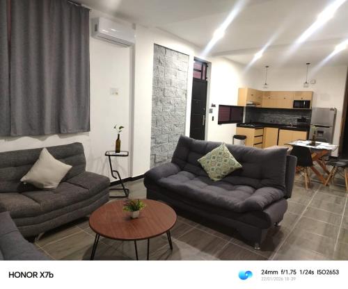 a living room with a couch and a table at Suite Departamento Nuevo in Aguascalientes